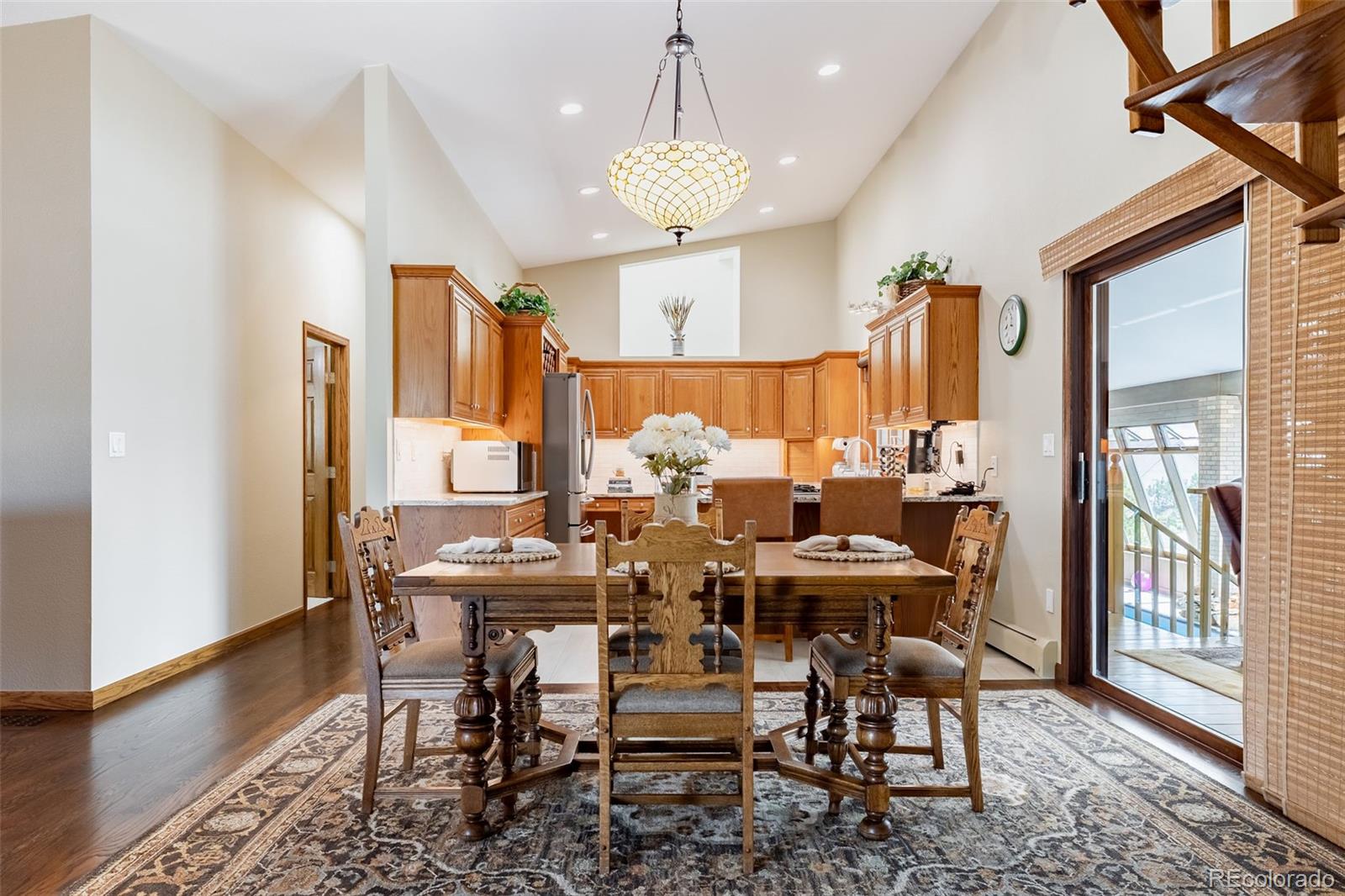 16609 West 77th Drive Arvada, CO 80007 - Photo 8 of 48 a view of a dining room with furniture window and wooden floor