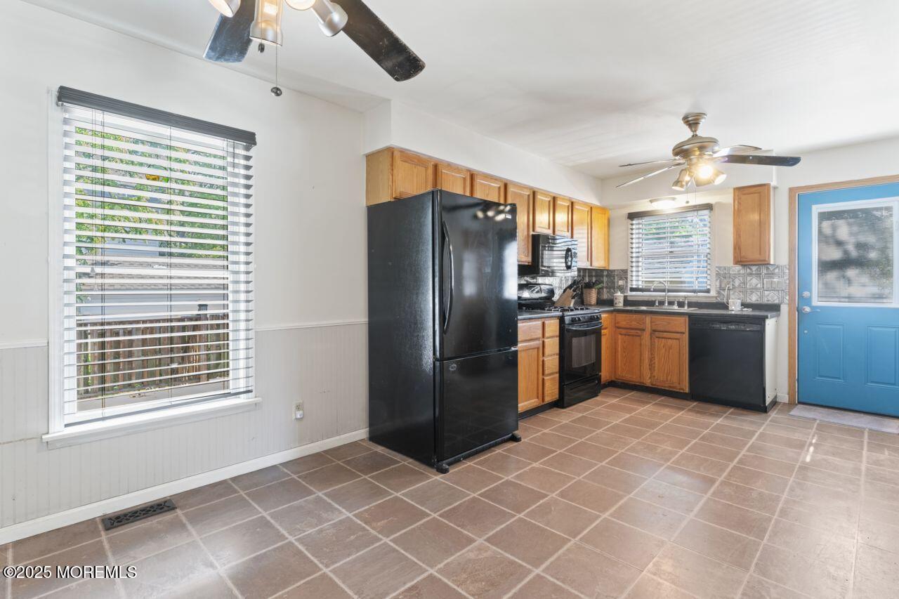 45 Letts Landing Road Waretown, NJ 08758 - Photo 16 of 28 a kitchen with stainless steel appliances granite countertop a refrigerator a sink a stove and cabinetry