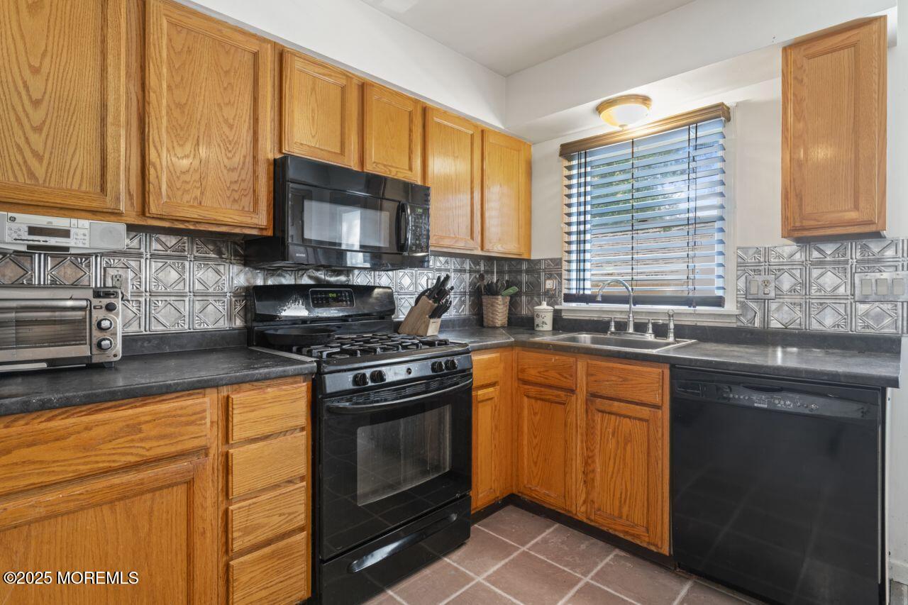 45 Letts Landing Road Waretown, NJ 08758 - Photo 18 of 28 a kitchen with stainless steel appliances granite countertop a sink stove and microwave
