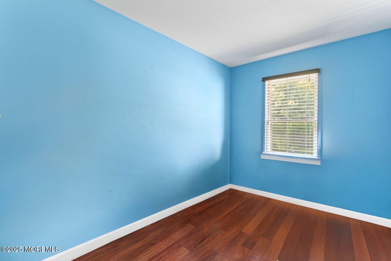 45 Letts Landing Road Waretown, NJ 08758 - Photo 23 of 28 a view of an empty room with wooden floor and a window