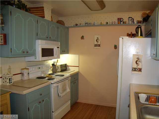 105 Ridgecrest Drive King, NC 27021 - Photo 9 of 15 Kitchen. Newly painted cabinets (inside & out). Shows range/oven & built-in microwave.