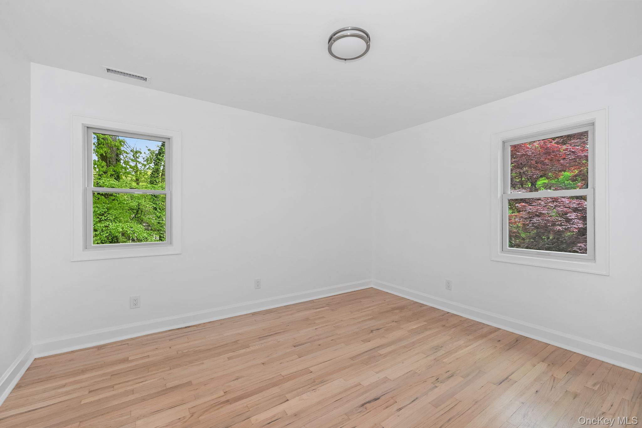 24 Country Road Mamaroneck, NY 10543 - Photo 17 of 37 wooden floor in an empty room with a window