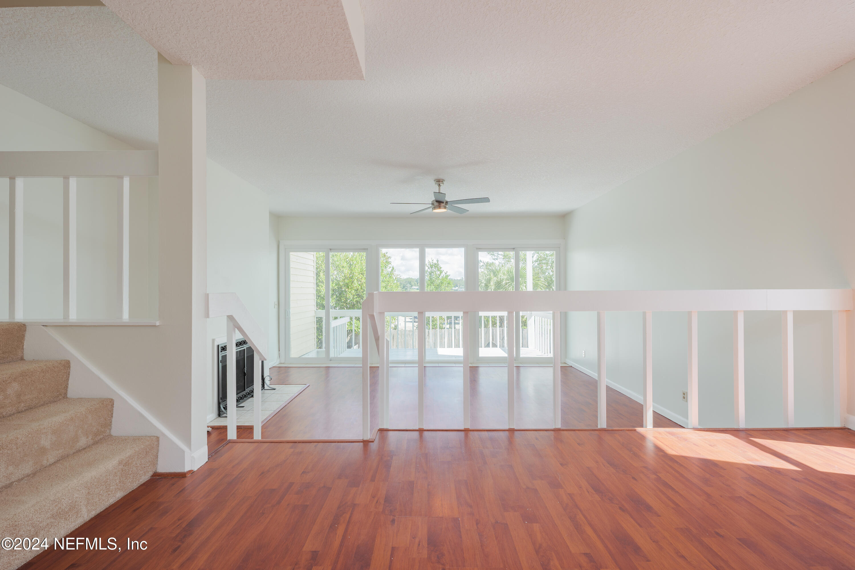 327 Scenic Point Lane Fleming Island, FL 32003 - Photo 16 of 54 a view of an empty room with wooden floor and a window