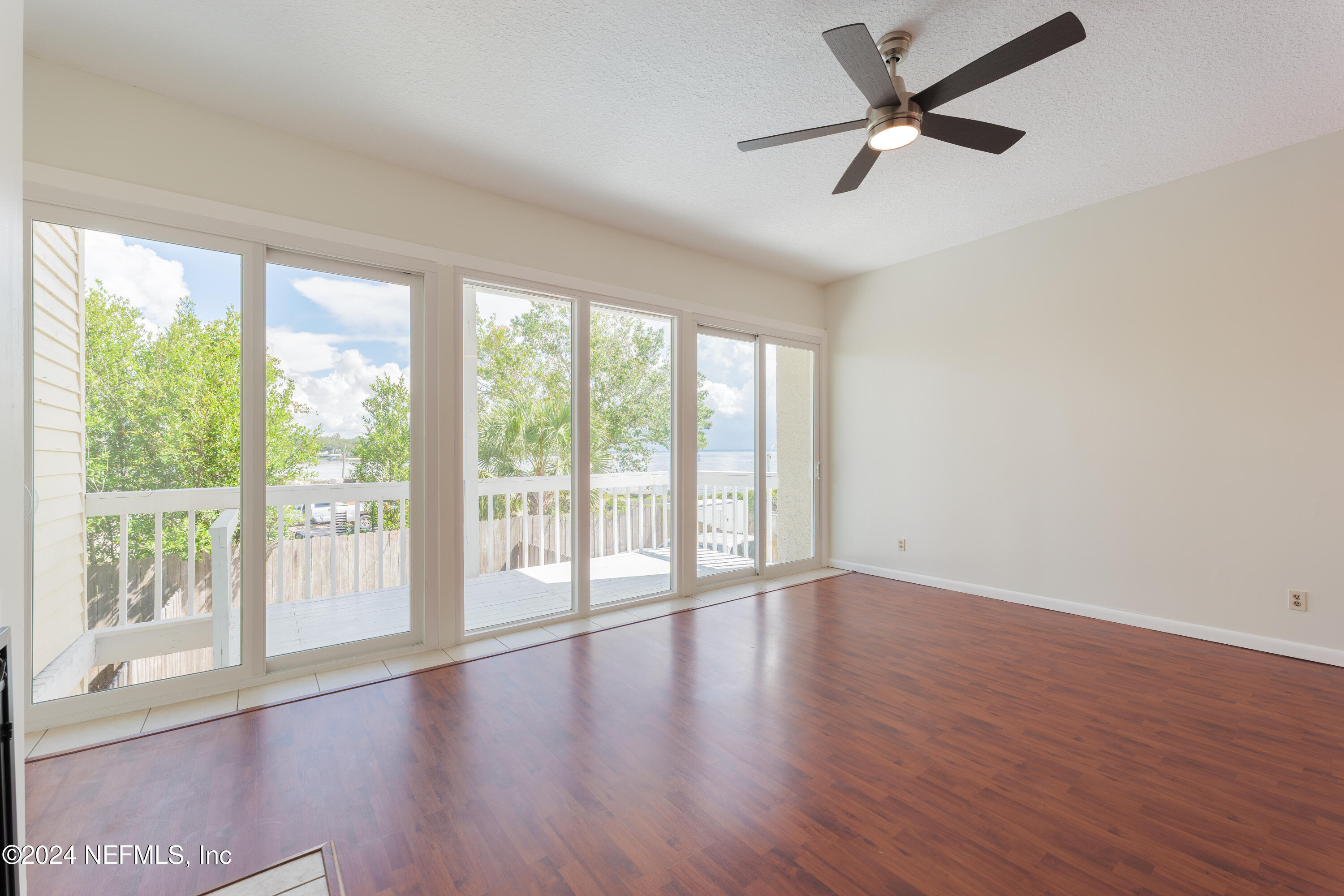 327 Scenic Point Lane Fleming Island, FL 32003 - Photo 18 of 54 a view of an empty room with wooden floor and a window