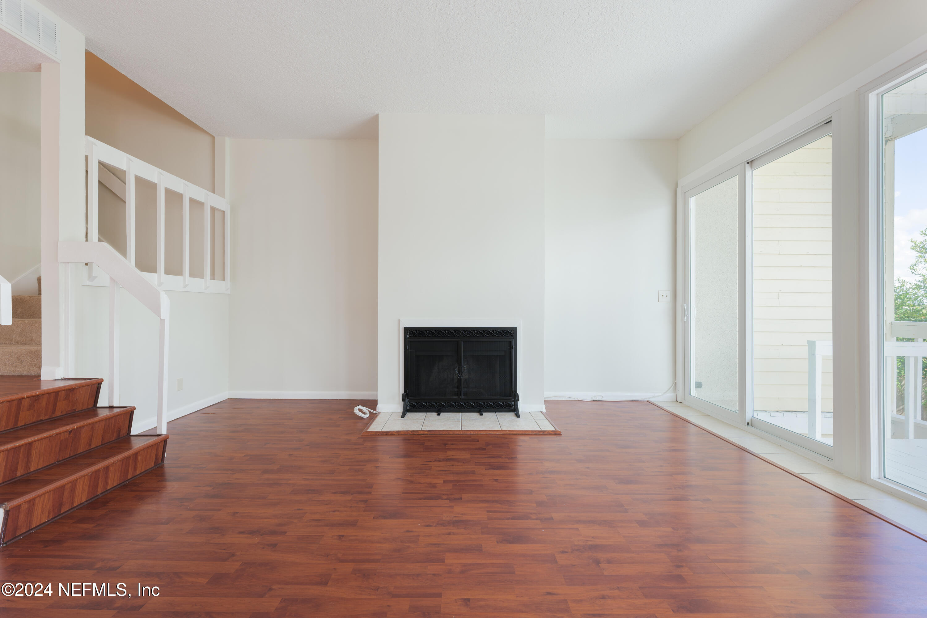327 Scenic Point Lane Fleming Island, FL 32003 - Photo 21 of 54 a view of an empty room with wooden floor and a window