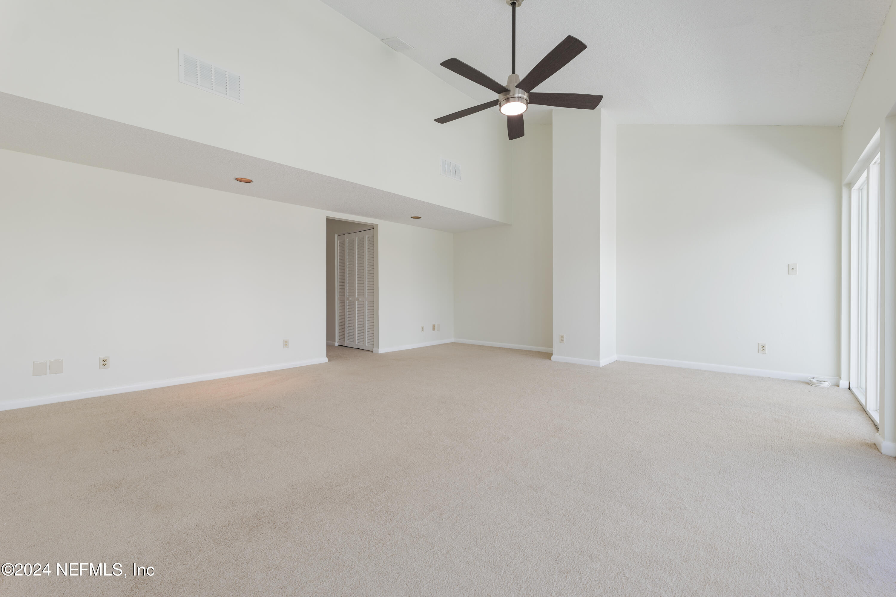 327 Scenic Point Lane Fleming Island, FL 32003 - Photo 25 of 54 an empty room with a ceiling fan and a window