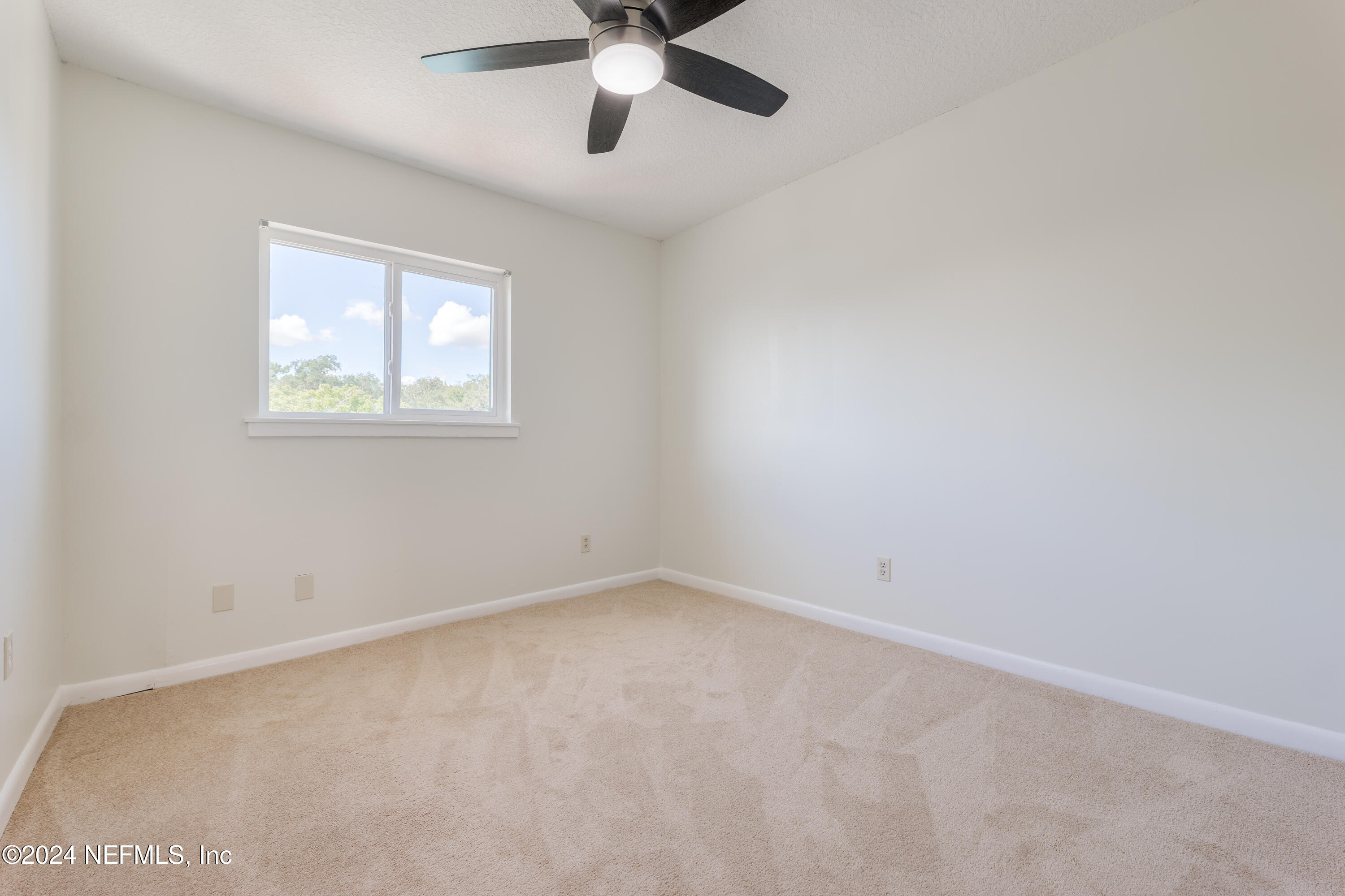 327 Scenic Point Lane Fleming Island, FL 32003 - Photo 34 of 54 an empty room with a window and a fan
