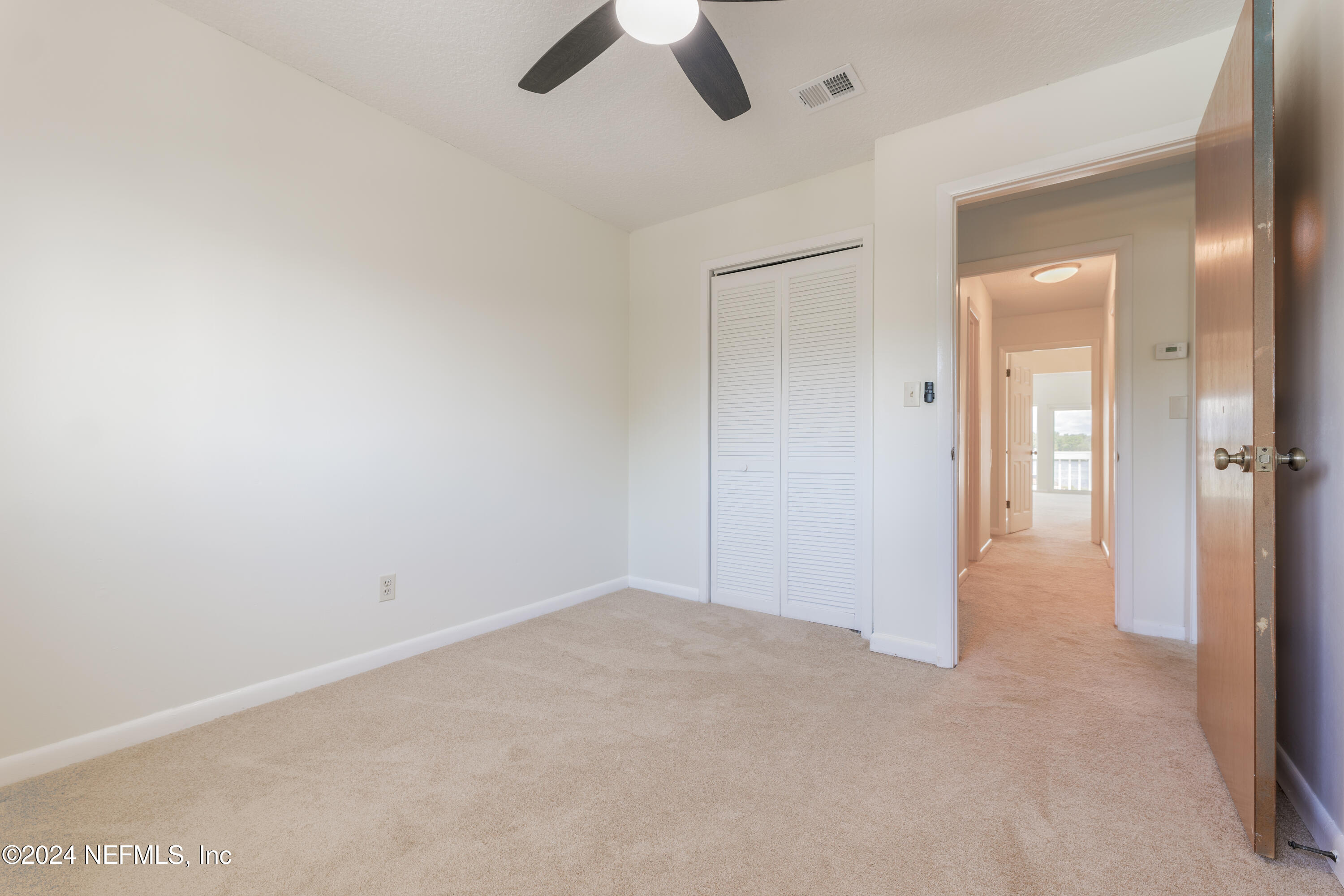 327 Scenic Point Lane Fleming Island, FL 32003 - Photo 35 of 54 an empty room with a empty space and a ceiling fan