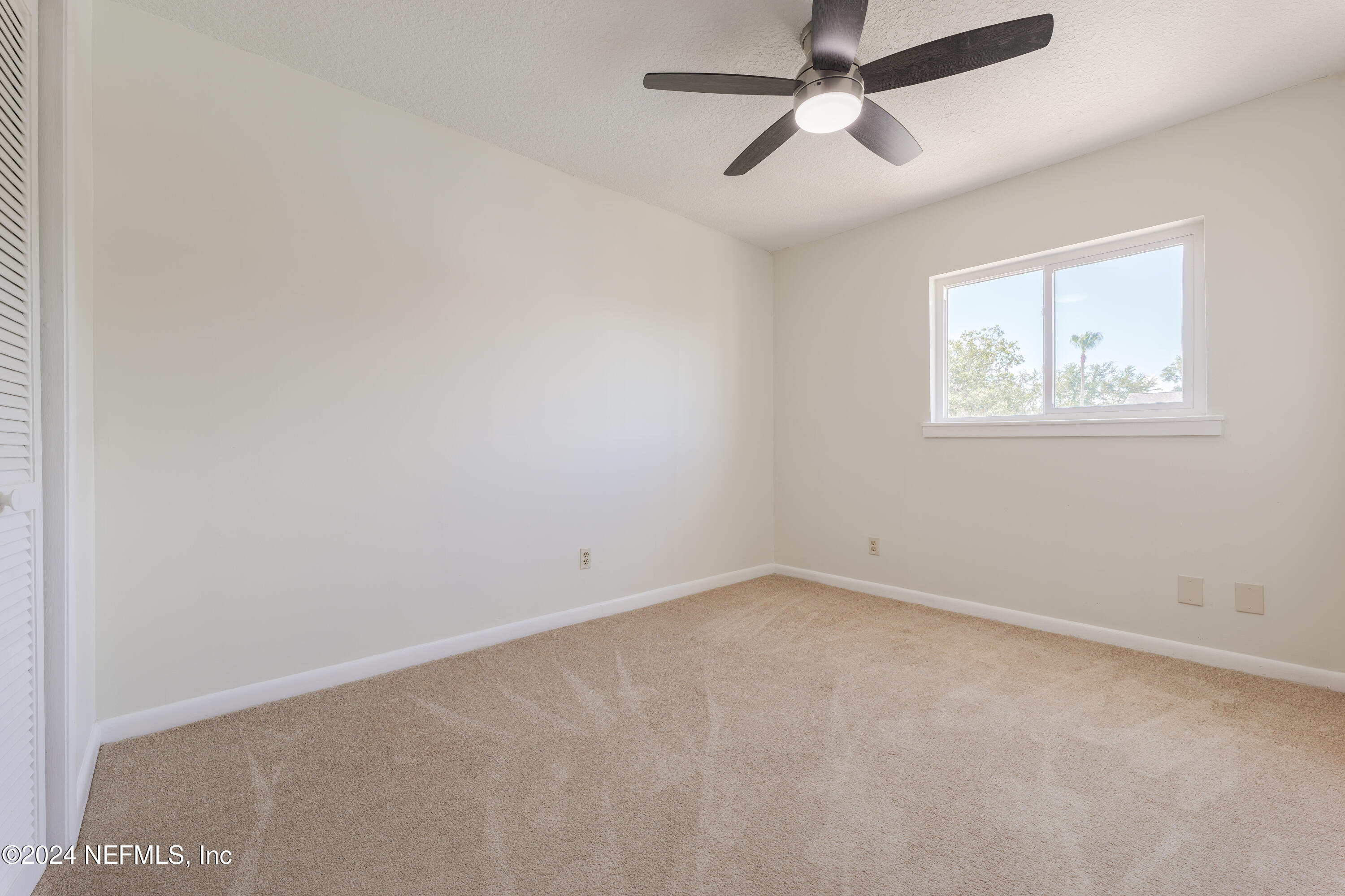 327 Scenic Point Lane Fleming Island, FL 32003 - Photo 37 of 54 an empty room with windows and fan