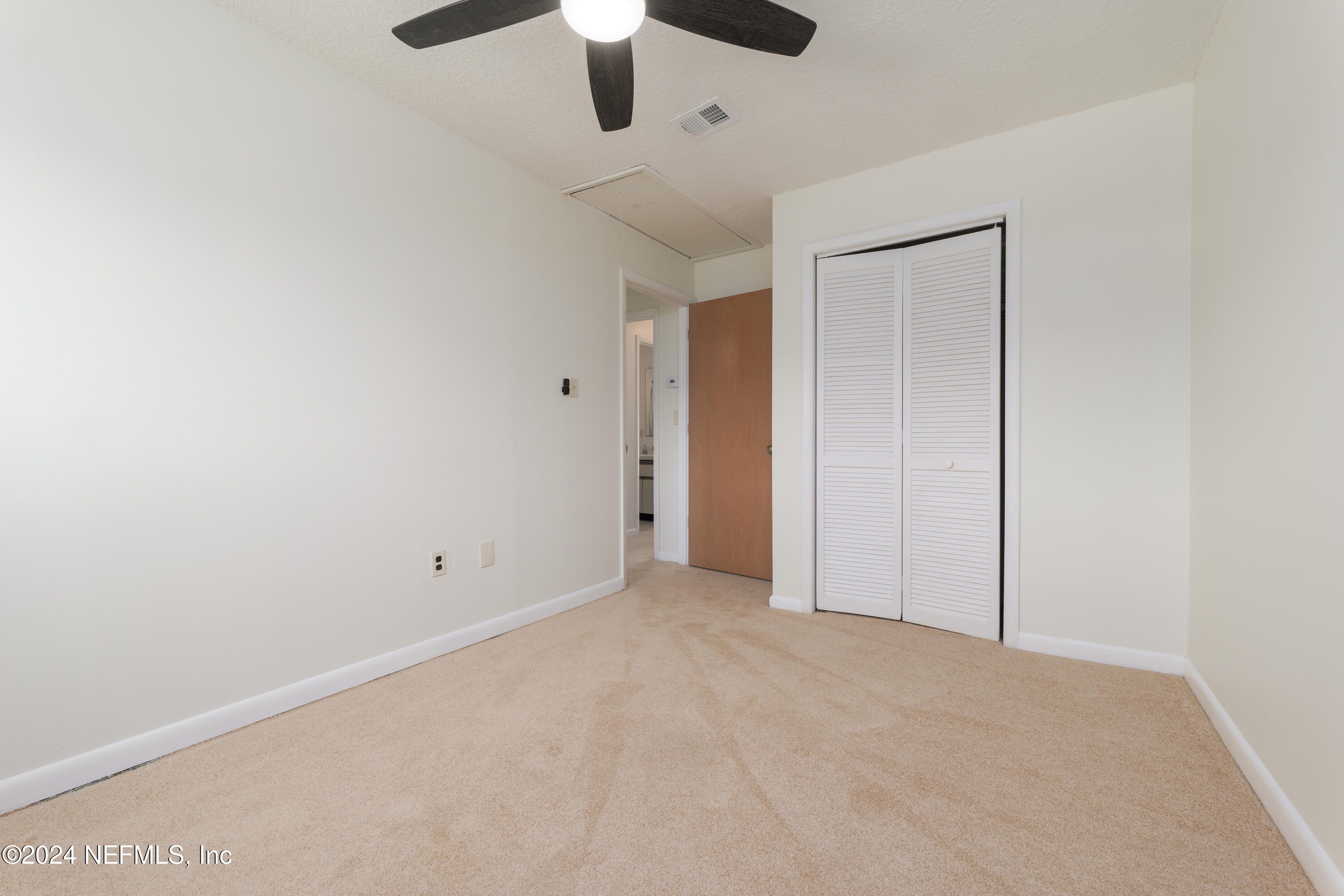 327 Scenic Point Lane Fleming Island, FL 32003 - Photo 38 of 54 an empty room with chandelier fan and closet