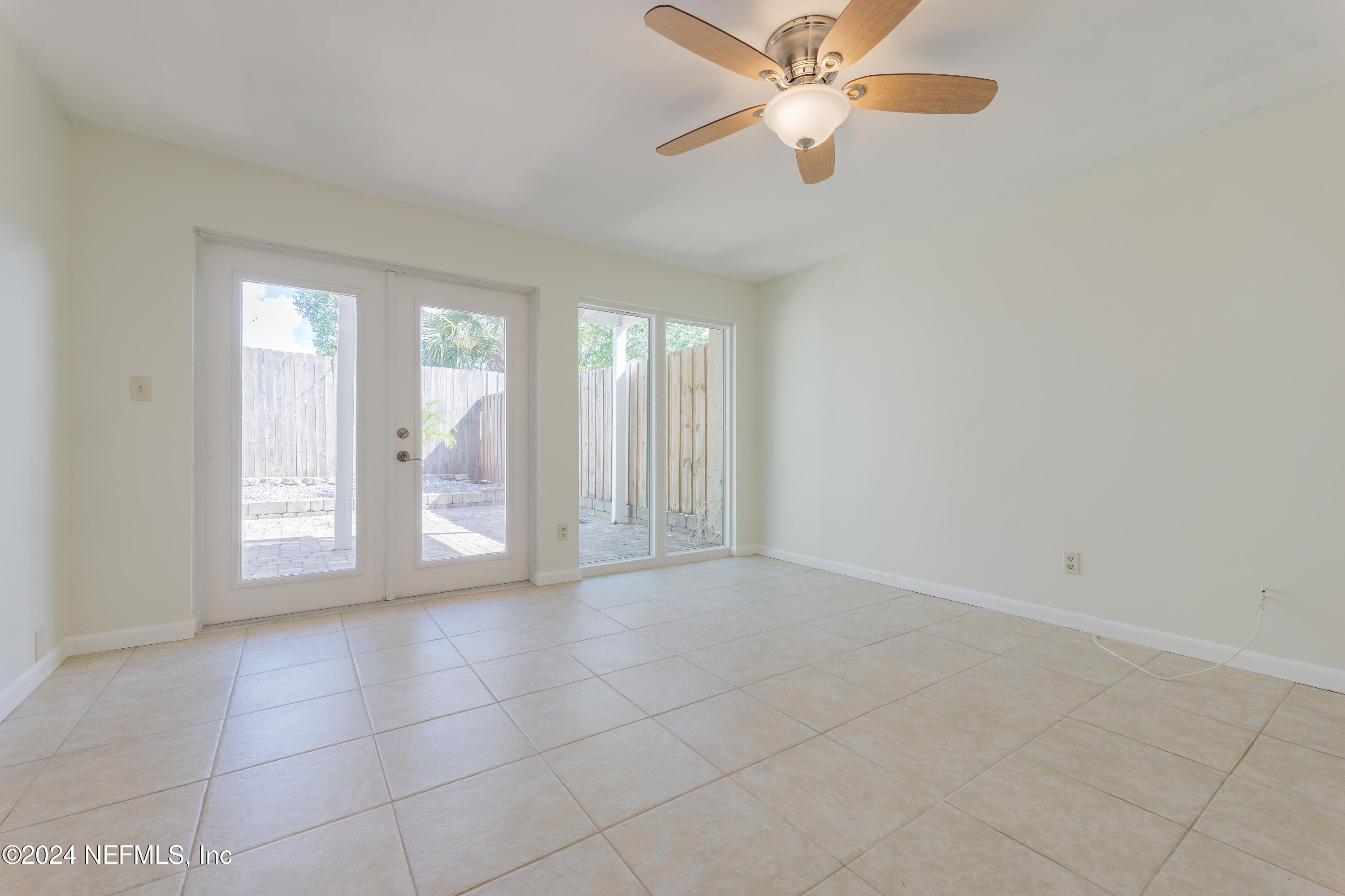 327 Scenic Point Lane Fleming Island, FL 32003 - Photo 39 of 54 an empty room with chandelier fan and windows