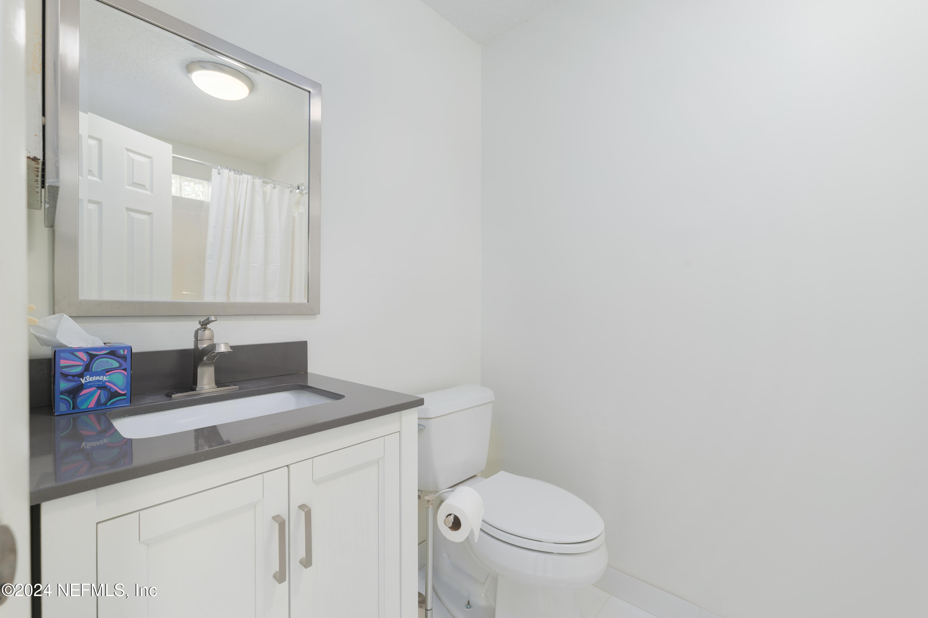 327 Scenic Point Lane Fleming Island, FL 32003 - Photo 41 of 54 a bathroom with a granite countertop sink a toilet and a mirror