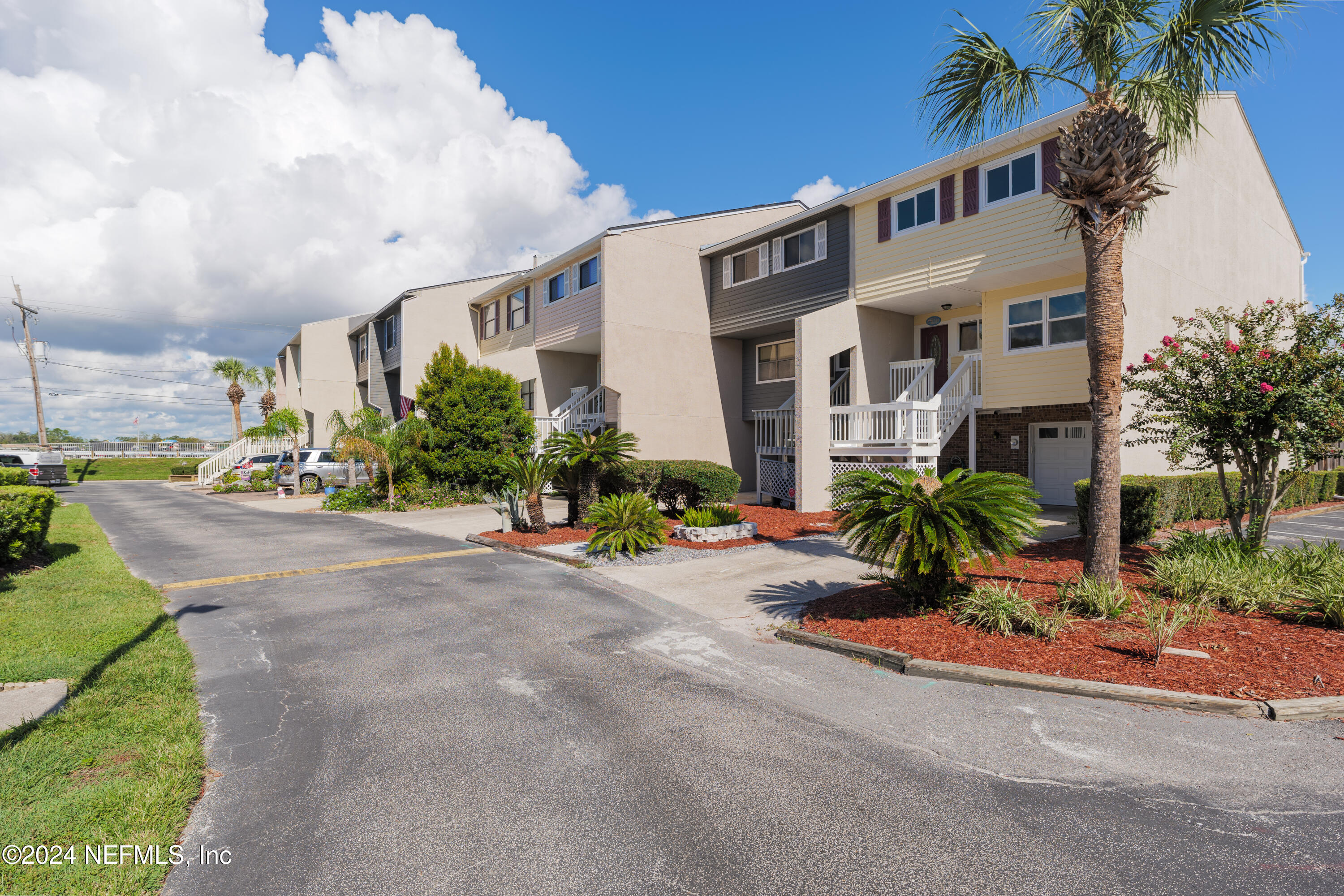 327 Scenic Point Lane Fleming Island, FL 32003 - Photo 8 of 54 a front view of a house with a yard and potted plants
