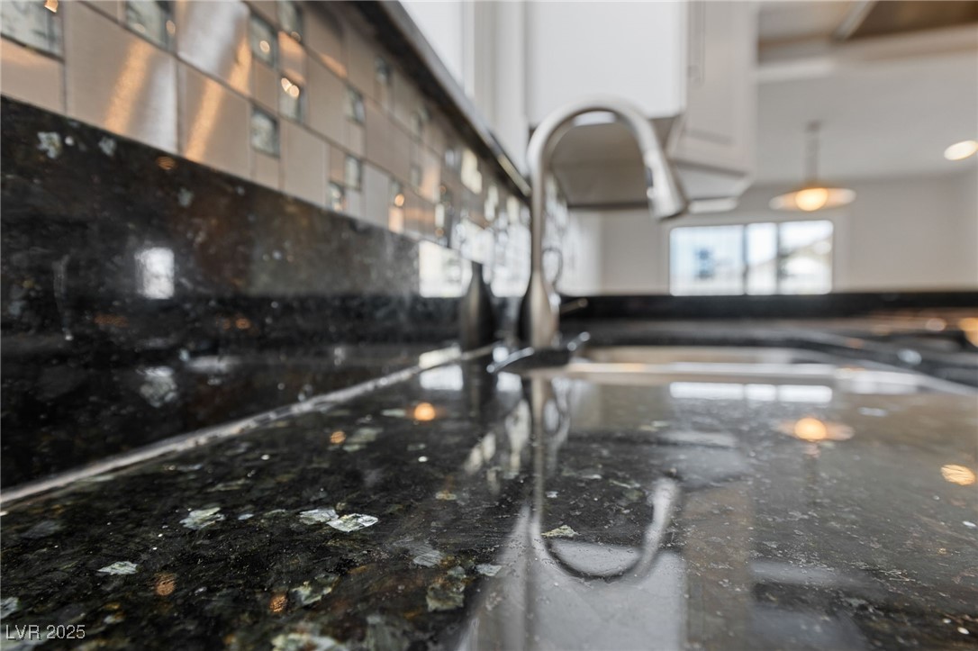 4272 East Russell Road Las Vegas, NV 89120 - Photo 3 of 19 Details featuring dark stone counters and white cabinetry
