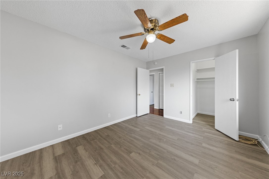 4272 East Russell Road Las Vegas, NV 89120 - Photo 8 of 19 Unfurnished bedroom featuring visible vents, light wood-style flooring, baseboards, and a textured ceiling