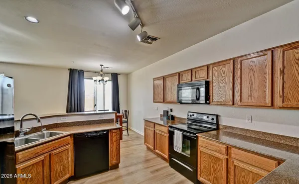 a kitchen with stainless steel appliances granite countertop a stove and a sink