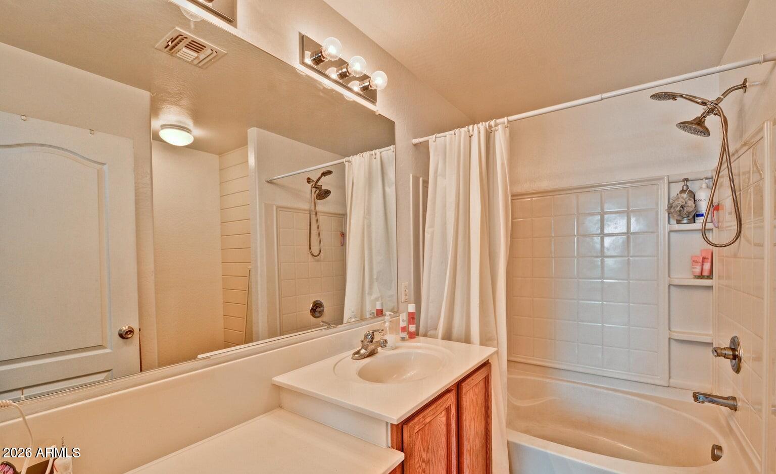 8169 West Groom Creek Road Phoenix, AZ 85043 - Photo 4 of 23 a bathroom with a granite countertop sink a mirror and a bathtub