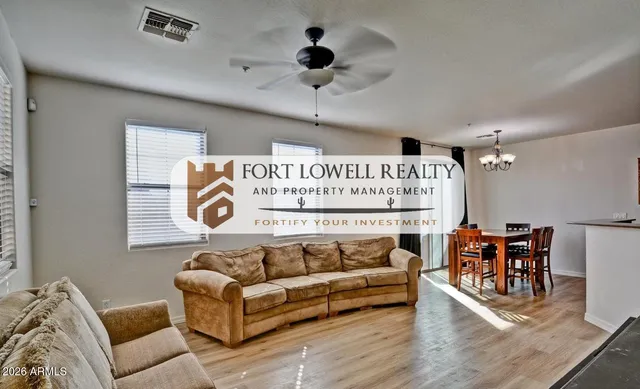a living room with furniture and a ceiling fan