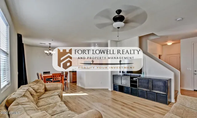 a living room with furniture and a ceiling fan