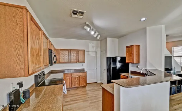 a kitchen with a sink cabinets and refrigerator