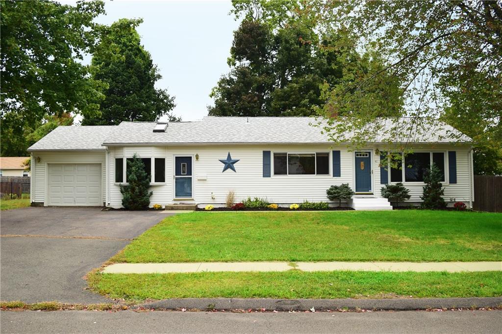 a front view of a house with a garden and porch
