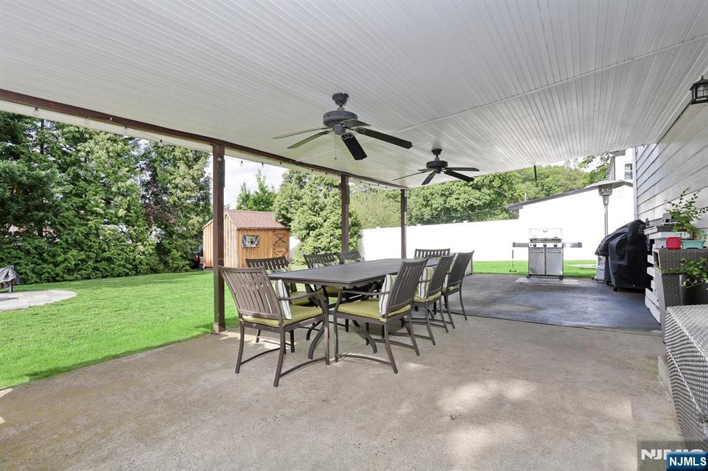 87 Barbara Road Dumont, NJ 07628 - Photo 45 of 48 a view of a patio with a table chairs and a backyard