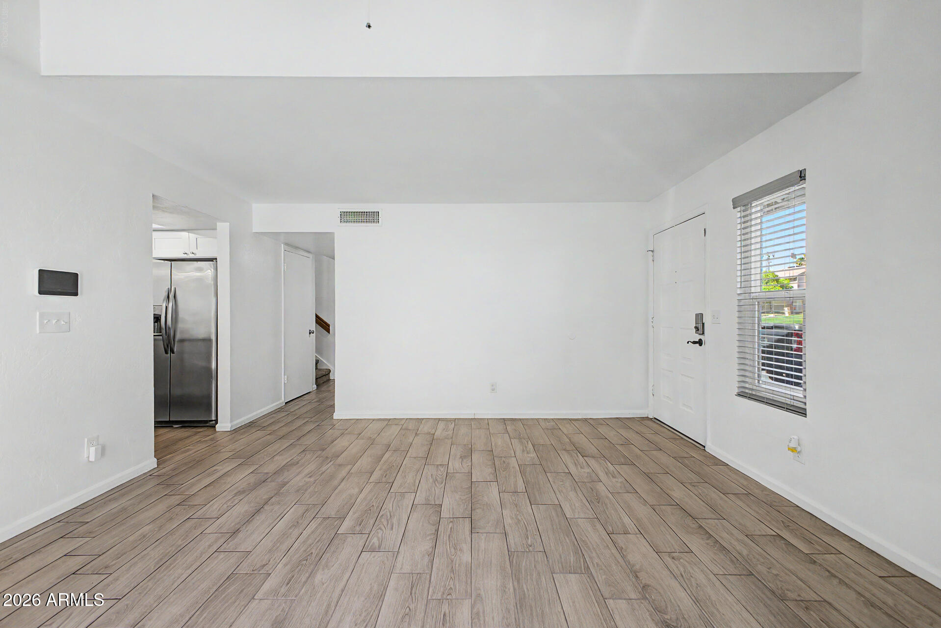 2455 East Broadway Road, Unit 103 Mesa, AZ 85204 - Photo 6 of 22 a view of a livingroom with wooden floor and a window