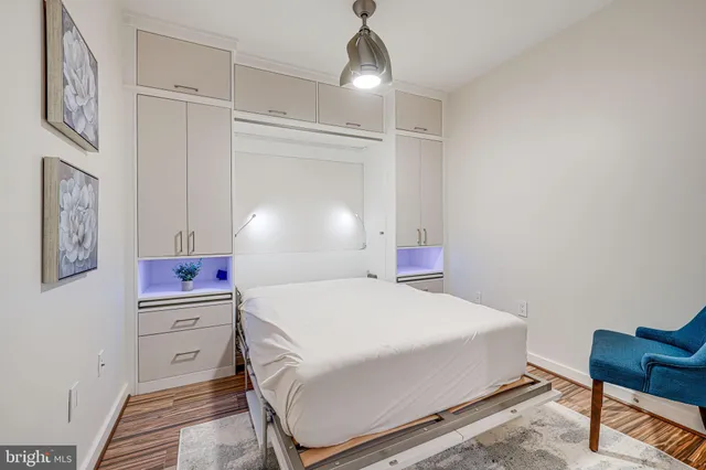 a bathroom with a granite countertop sink toilet a mirror and shower