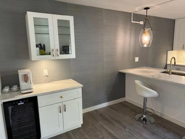 a spacious bathroom with a granite countertop sink a toilet and a mirror