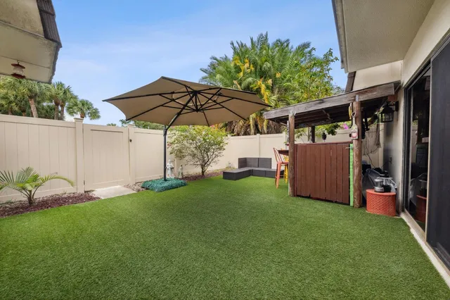 a view of a backyard with under an umbrella