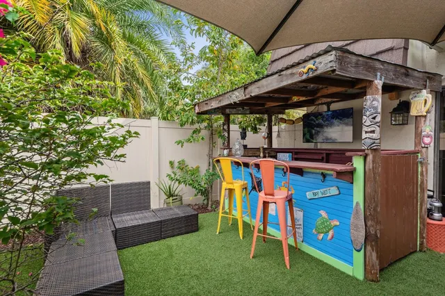 a view of an chairs and table in the patio