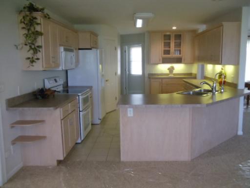 204 Ken Street Dwight, IL 60420 - Photo 7 of 14 a kitchen with stainless steel appliances granite countertop a sink a stove and a refrigerator
