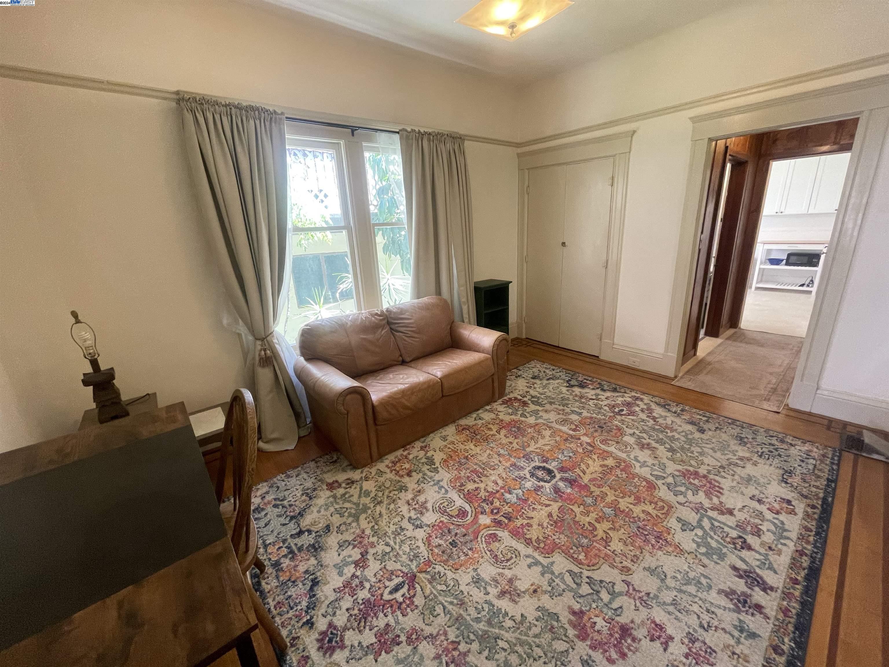 Adams Point Oakland, CA 94610 - Photo 12 of 16 a living room with furniture and a rug