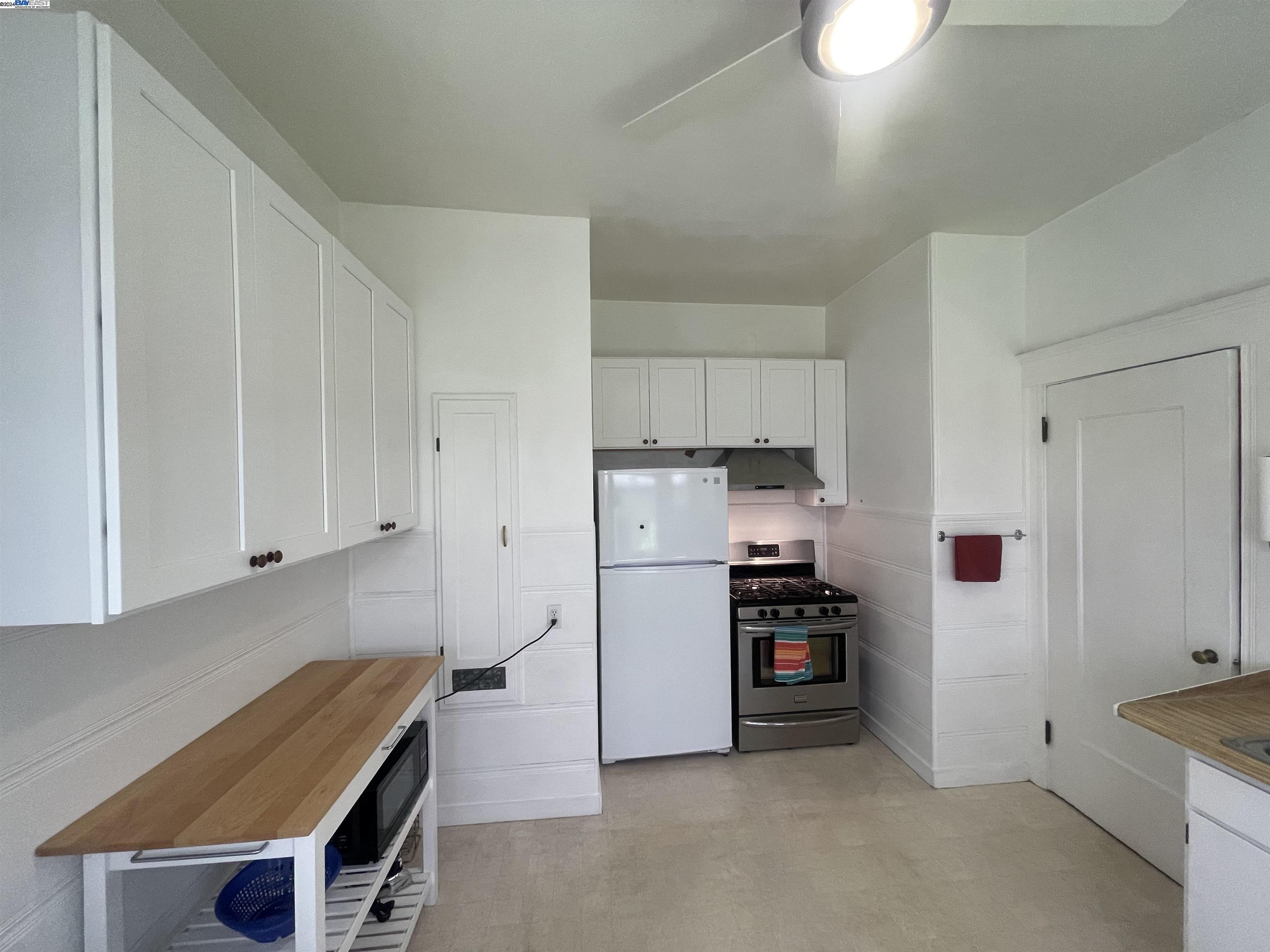 Adams Point Oakland, CA 94610 - Photo 8 of 16 a kitchen with stainless steel appliances a refrigerator and stove