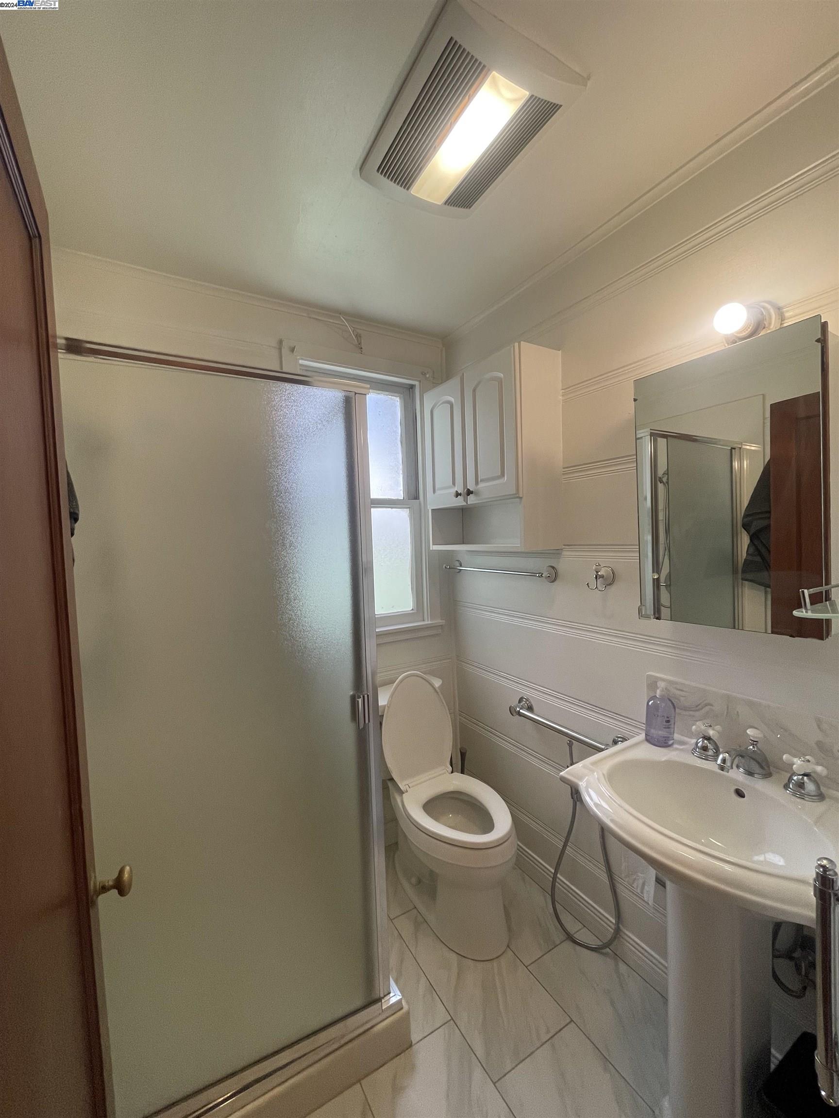 Adams Point Oakland, CA 94610 - Photo 10 of 16 a bathroom with a granite countertop sink toilet and shower