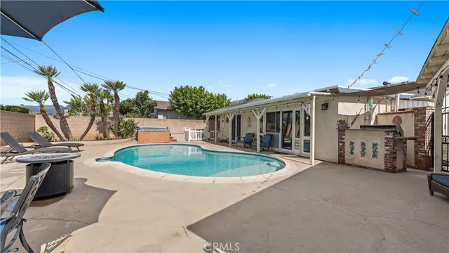 a front view of a house with a yard and seating area