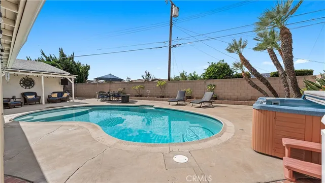 a pathway of a house with a yard and potted plants