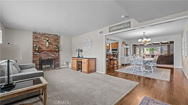 a living room with furniture a table and a fireplace