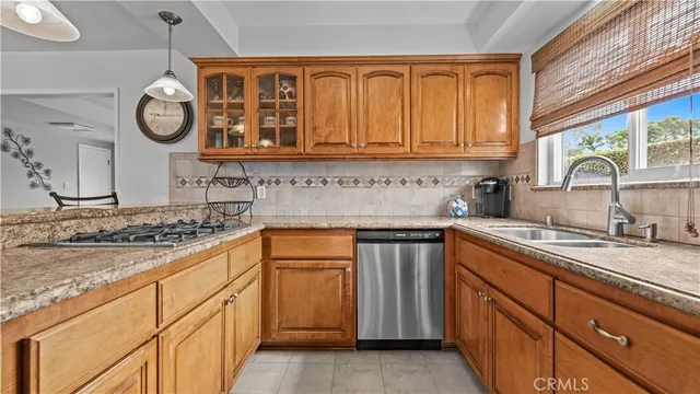 a kitchen with stainless steel appliances granite countertop white cabinets sink and dishwasher