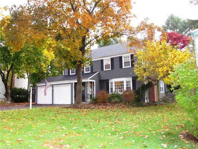 a front view of house with yard and trees