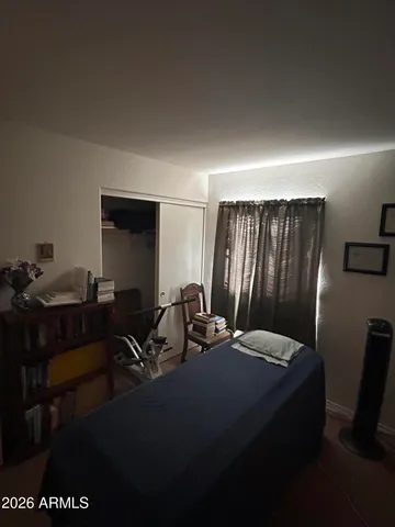 a bedroom with a bed and a dresser