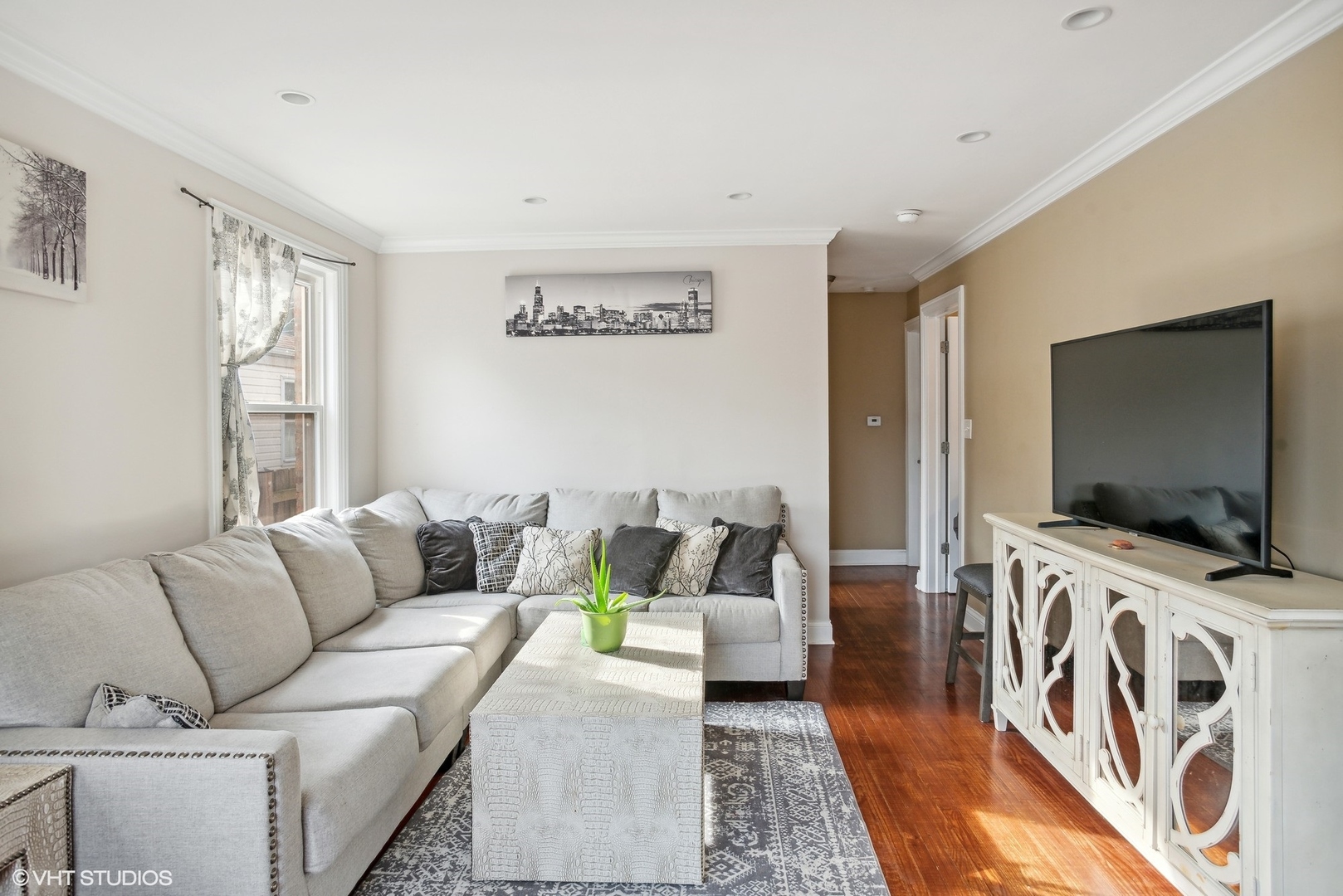 2412 Greenleaf Street Evanston, IL 60202 - Photo 4 of 20 a living room with furniture and a flat screen tv