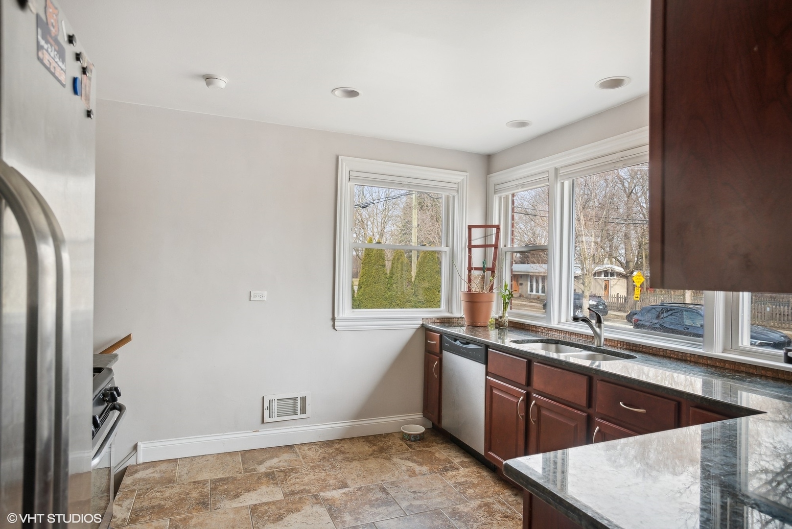 2412 Greenleaf Street Evanston, IL 60202 - Photo 7 of 20 a kitchen with a sink window and cabinets