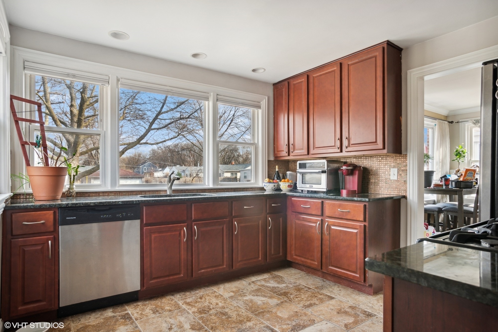 2412 Greenleaf Street Evanston, IL 60202 - Photo 8 of 20 a kitchen with stainless steel appliances granite countertop wooden cabinets a stove and a granite counter top