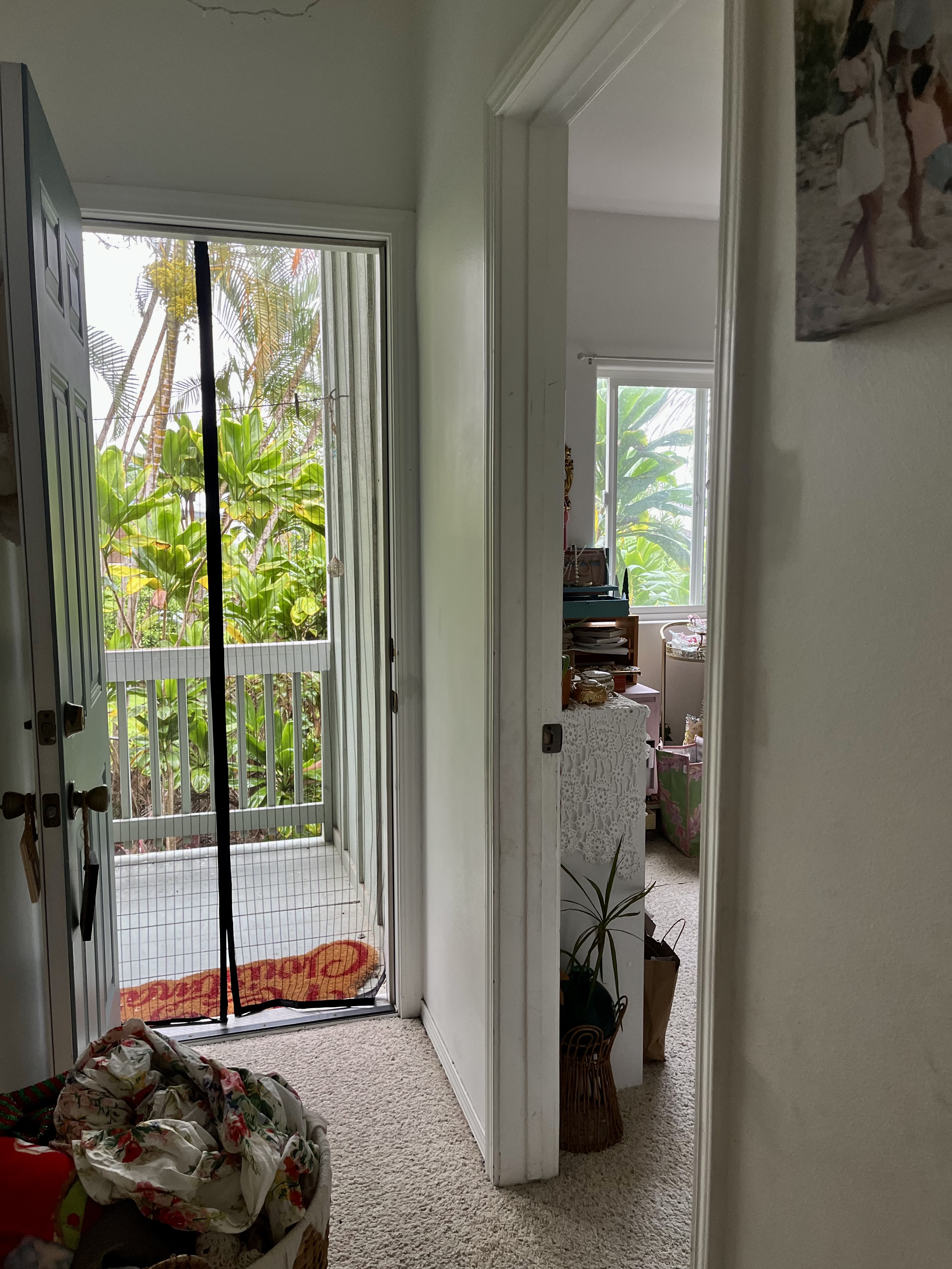 24 Manu Place Hilo, HI 96720 - Photo 11 of 16 a bedroom with a bed and a floor to ceiling window