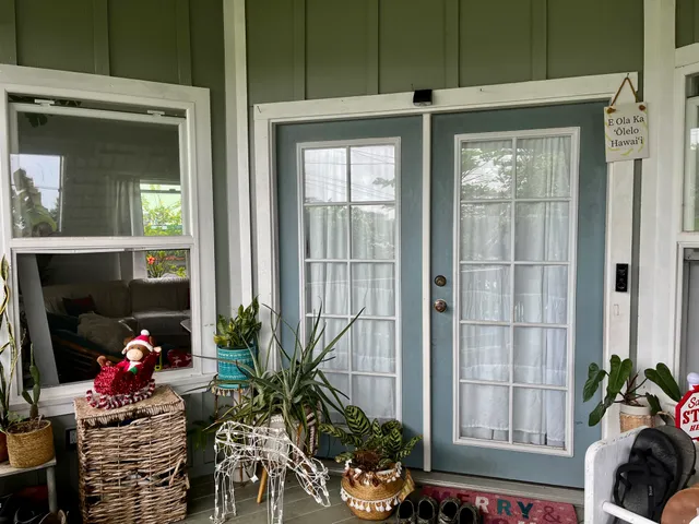 a living room filled with furniture and a potted plant