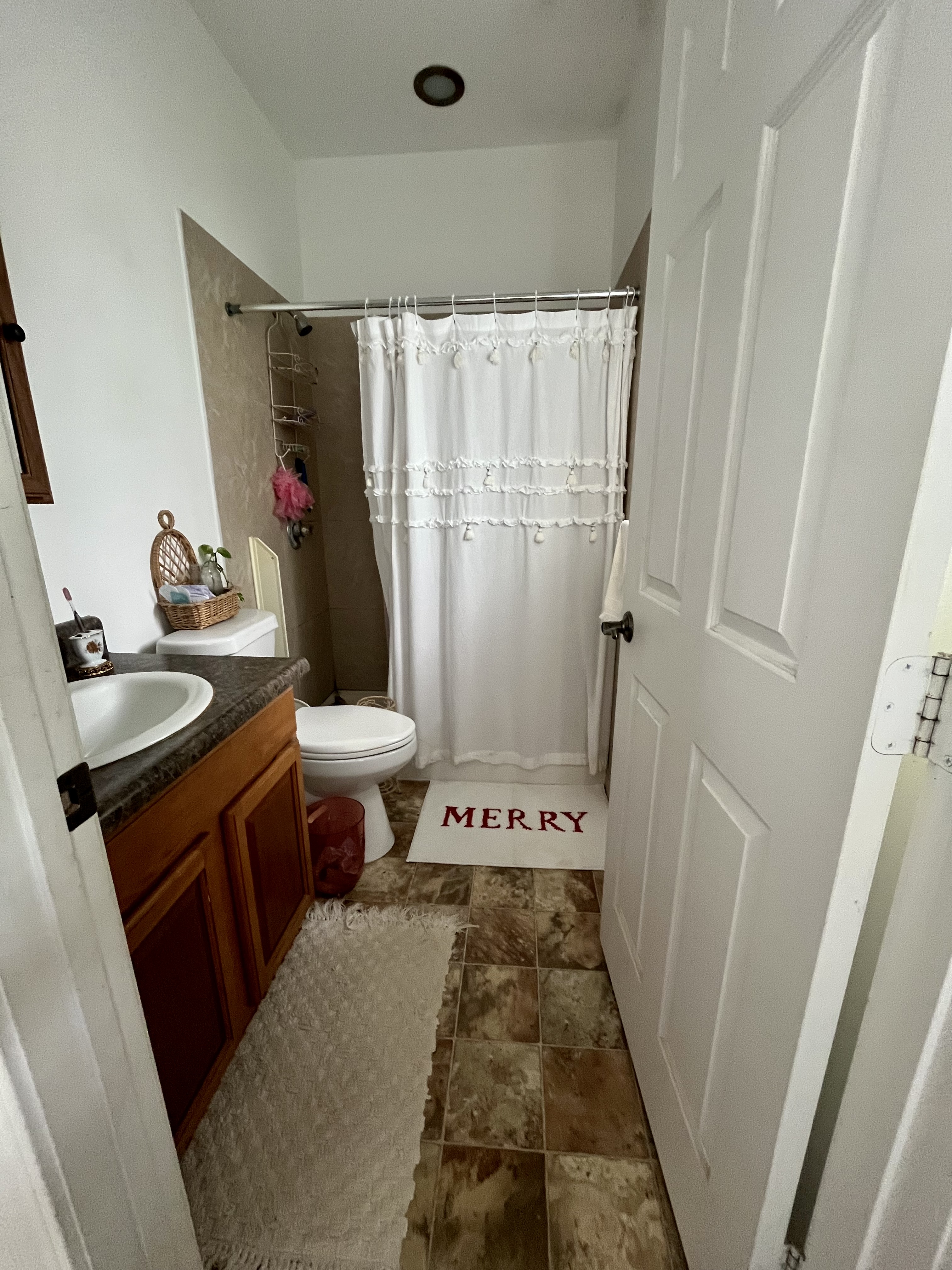 24 Manu Place Hilo, HI 96720 - Photo 8 of 16 a bathroom with a sink a toilet a mirror and shower curtain