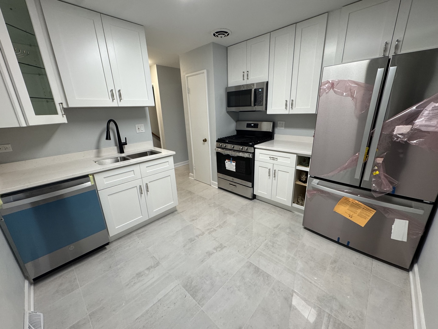 4912 Crain Street, Unit C Skokie, IL 60077 - Photo 5 of 15 a kitchen with stainless steel appliances granite countertop a refrigerator sink and stove