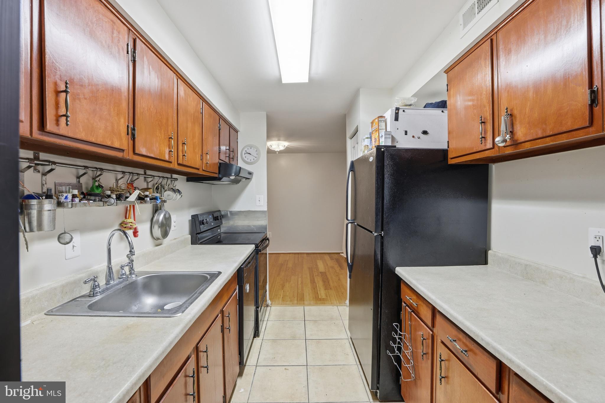 427 Christopher Avenue, Unit T2 Gaithersburg, MD 20879 - Photo 11 of 28 a kitchen with stainless steel appliances granite countertop a sink stove and refrigerator