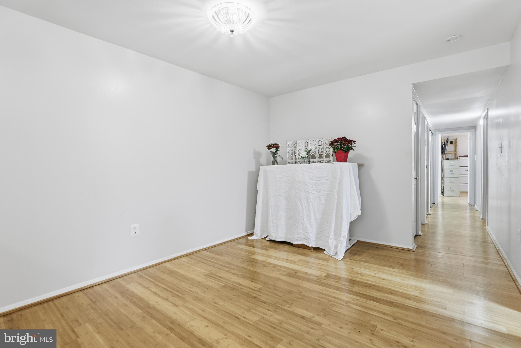 427 Christopher Avenue, Unit T2 Gaithersburg, MD 20879 - Photo 13 of 28 a view of a room with wooden floor and ceiling fan